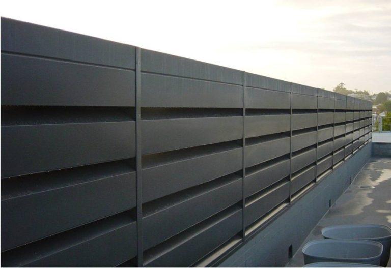 Black powder coated 1/300 acoustic louver on building exterior.